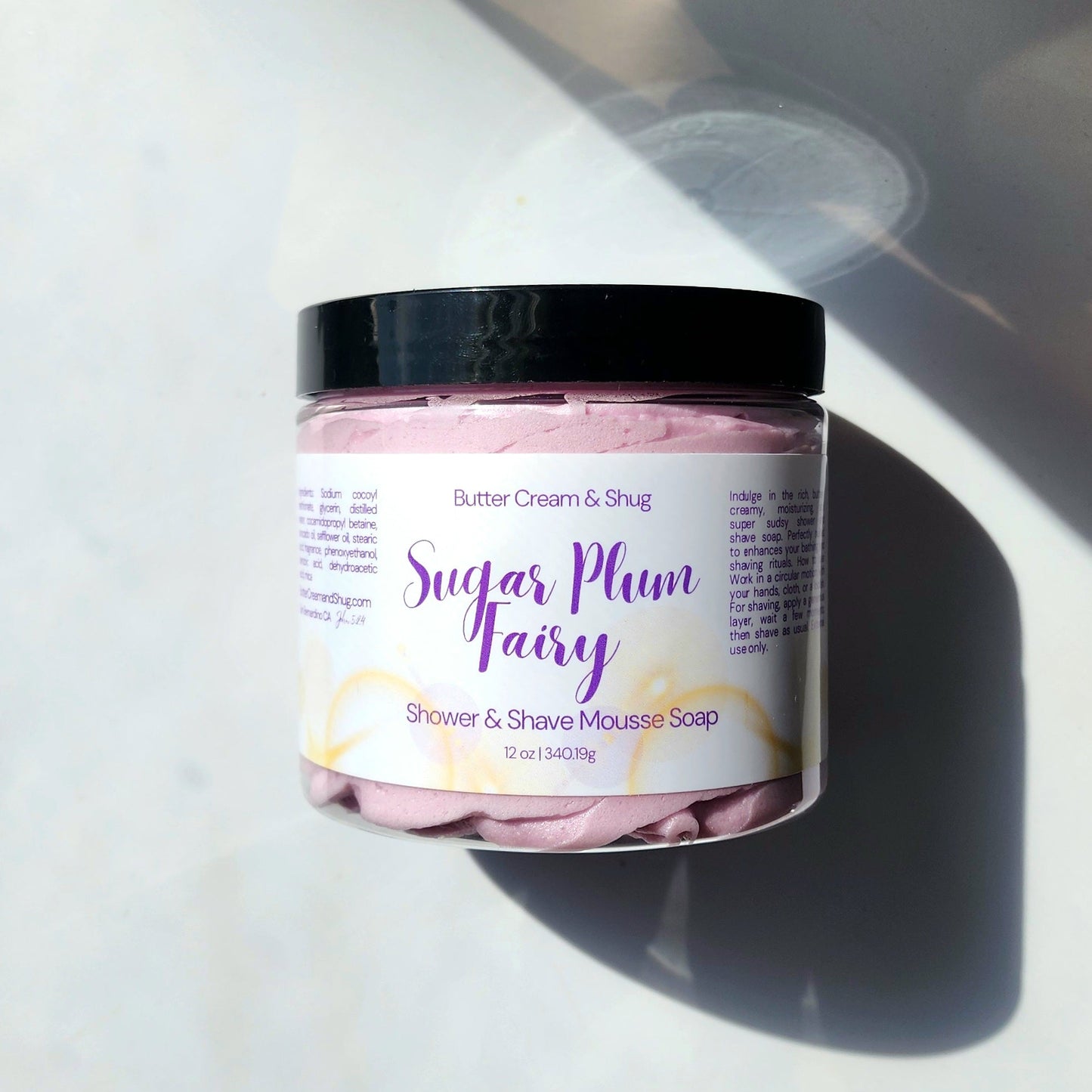 Jar of 'Sugar Plum Fairy' shower and shave mousse soap on a white surface